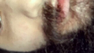 A woman strokes and sucks a big black cock to make it harder