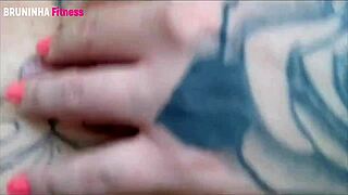 Watch this seductive babe flaunt her amazing body and tattoos in a steamy video