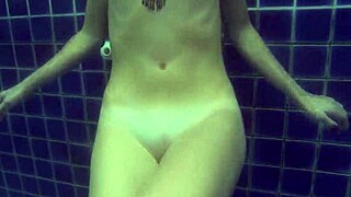 Wendy, the blonde bombshell, sensually swimming naked in the pool