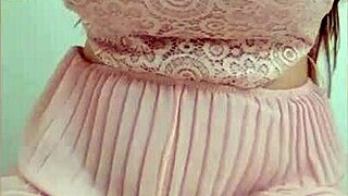 A young woman in a pink dress exposes her big boobs and starts to play with them, giving great pleasure.