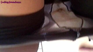 A goddess alone, wearing orange socks and pantyhose, rubbing herself.