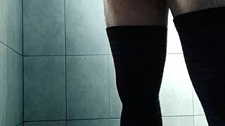 Gay guy strokes his cock in stockings