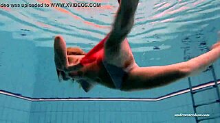 Beautiful European woman Duna Bultihalo in a red dress in the pool