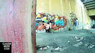 Lovebirds have sex in front of a wall in the street