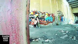 Lovebirds have sex in front of a wall in the street