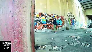 Lovebirds have sex in front of a wall in the street