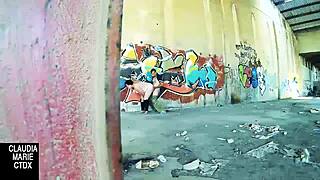 Lovebirds have sex in front of a wall in the street