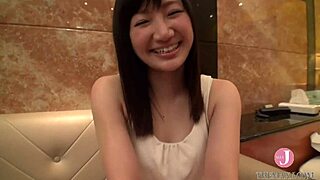 A beautiful Asian woman starts her erotic experience by removing her coat