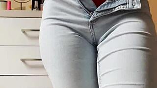 Pretty blonde performs a sexy striptease in tight jeans