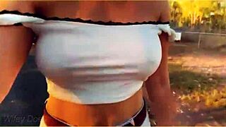 A hot mom is flashing her tits while riding a bike in public