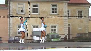 Two charming majorettes in a beautiful uniform are shining with beauty