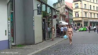 A sexy girl is walking naked on the city streets