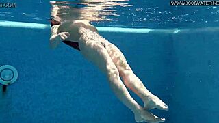 Nicole Pearl, a sexy MILF, swims in the pool and shows off her slim body
