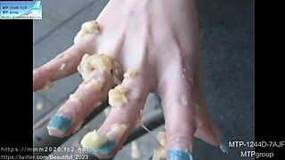 Young Japanese girl gets a manicure with acrylic nails on her fingers